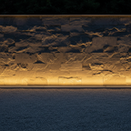 Minimalist Slate Stone Wall with Warm LED Ground Uplighting at Night